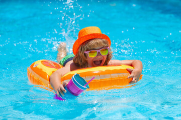 Wall Mural - Boy kid swimming and playing in a pool. Child playing in swim pool. Summer vacation concept. Summer fashion kids portrait.