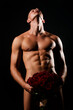 © Volodymyr - Sexy valentine. Male sex. Gay with a naked nude torso and roses bouquet hiding penis. Sexy muscle gay hiding male genital isolated on black. Sexy valentines day. Hot gay. Sexy valentine.