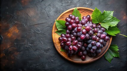 Wall Mural - Ripe purple grapes with leaves on wooden plate on dark background, grapes, juicy, ripe, purple, green, red