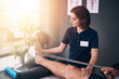 © peopleimages.com - Physiotherapist, legs and woman with recovery, band and resistance training for injury. Help, physical therapy and patient with consultation, rehabilitation exercise and stretch for muscle strength
