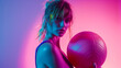 © retrostudio - Confident fitness woman posing with a medicine ball. Attractive blonde sportswoman portrait holding with medicine fitness ball