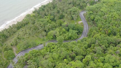 Wall Mural - Aerial view of cars driving on highway or moterway. Overpass bridge street roads in connection network of architecture concept. Top view of forest trees. Nature landscape