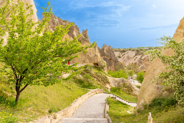 Wall Mural - Türkiye Cappadocia Fairy Chimneys as Peri Bacalari. Volcanic rock landcsape of Fairy tale chimneys in Cappadocia with blue sky on background in Goreme, Nevsehir