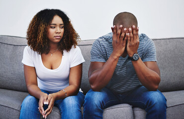 Canvas Print - Frustrated couple, fight and argument with breakup on sofa for disagreement or cheating affiar at home. Sad man and woman in toxic relationship, divorce or confession in living room conflict at house