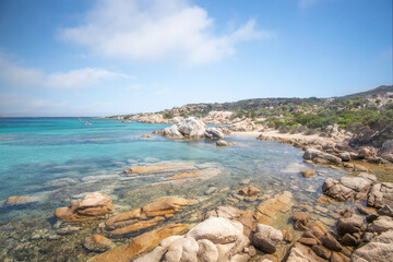 Wall Mural - Le littoral de Sardaigne en Italie, l'eau turquoise de la mediterranée et la plage de bassa trinita parsemée de rochers.