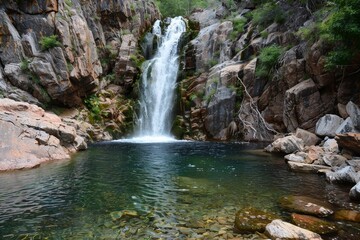 Sticker - A large waterfall cascading down a rocky cliff in the heart of a lush forest, A waterfall cascading down a rocky cliff into a crystal-clear pool below