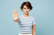 © ViDi Studio - Young sad strict serious woman wear striped t-shirt casual clothes show stop gesture with palm look camera isolated on plain pastel light blue cyan color background studio portrait. Lifestyle concept