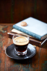 Wall Mural - Coffee in glass cup on dark background. Close up. Copy space.