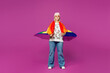 © ViDi Studio - Full body young confident happy lesbian woman wearing pink animal clothes with rainbow flag on shoulders isolated on plain purple background studio portrait. Pride day June month love LGBTQ concept.