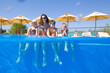 © yanlev - happy family swimming  in pool.  underwater photo.