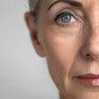 © Владимир Солдатов - A close-up of a mature Caucasian woman with a serene expression, promoting skincare and wellness