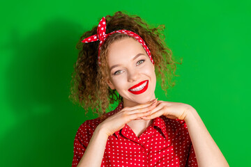 Poster - Photo portrait of attractive young woman demonstrate face toothy smile dressed stylish red retro clothes isolated on green color background