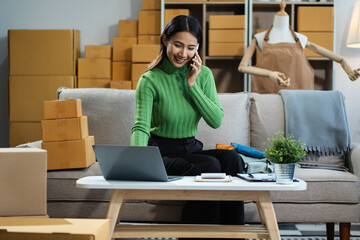 Wall Mural - Woman start up small business owner at workplace. small business entrepreneur SME or freelance asian woman working with box at home.