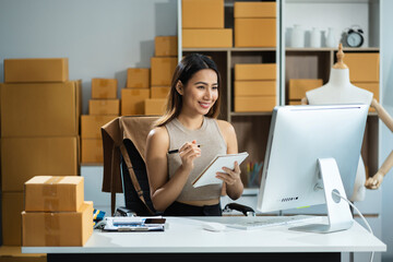 Wall Mural - Woman start up small business owner at workplace. small business entrepreneur SME or freelance asian woman working with box at home.