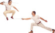 © Lustre Art Group  - Portrait of two men in suit fighting with swords, posing against transparent background. In jump. Concept of professional sport, hobby, movement, emotions, active lifestyle, retro fashion.