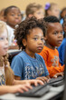 © ChubbyCat - Children of diverse backgrounds engaging in computer skills learning in a classroom setting.