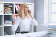 © H_Ko - Beautiful blonde smiling businesswoman talk cellphone in office portrait. Stay in touch best cellular price A woman is informed that she won a prize in the lottery by phone