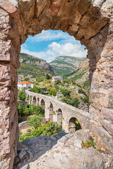 Wall Mural - Ancient aqueduct near Montenegro's Bar fortress, blending heritage with scenic mountains