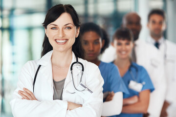 Wall Mural - Portrait, happy woman or confident doctors with leadership in hospital for healthcare services or about us. Teamwork, medical professional and nurses with pride or trust at wellness clinic