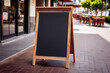 © Sadun - Empty wooden menu board in front of the Coffee Shop or restaurant in blurry background for mockup