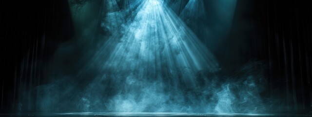 Wall Mural - a stark black background with a bright spotlight illuminating an empty stage.