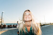 © Ilona - Wind in the hair. Lifestyle flash motion portrait of a cheerful  woman with long blond hair.