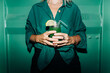 © Ilona - An unrecognizable woman holds a cool cocktail in her hands.