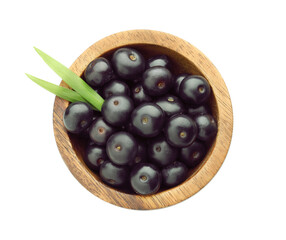 Wall Mural - Fresh ripe acai berries in bowl and green leaves isolated on white, top view