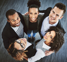 Canvas Print - Happy, office and above portrait of business people for teamwork, collaboration and solidarity in workplace. Company, diversity and top view of men and women hug for support, community and coworking