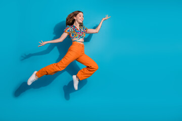 Wall Mural - Full body portrait of lovely young girl jump fly empty space wear top isolated on blue color background