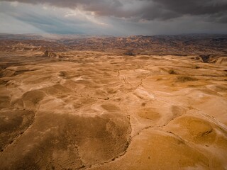 Sticker - Sweeping aerial view of the vast Judean Desert under a cloudy sky in Israel