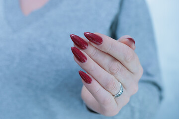 Wall Mural - Female hands with long nails and dark black red nail polish