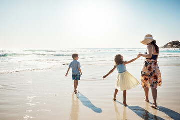 Wall Mural - Happy, holding hands and mother with children at beach on holiday, vacation and tropical adventure. Family, travel and kids with mom by ocean for bonding, playing in waves and fun outdoors on weekend