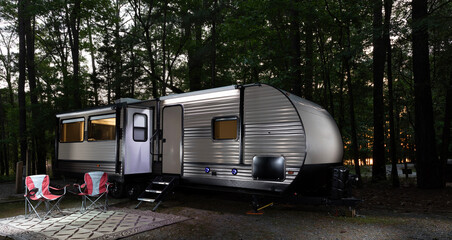 Canvas Print - Camper trailer set up in a thick forest