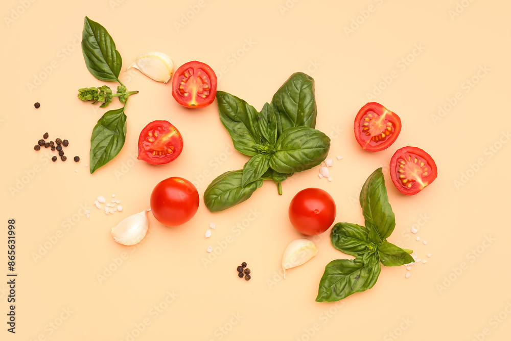 Fresh basil, cherry tomatoes and peppercorn on orange background