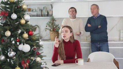 Wall Mural - Elderly and adult men quarreling with young woman in kitchen at home