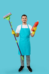 Poster - Male janitor with cleaning gel and mop on blue background