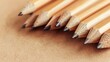 © TheWaterMeloonProjec - Wooden pencils on light brown backdrop with space for text