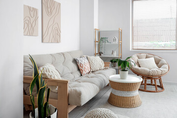Sticker - Interior of modern living room with comfortable sofa, coffee table, houseplants, armchair and pictures
