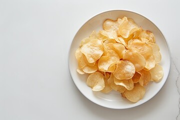 Wall Mural - Cassava chips on a white plate against a white backdrop