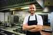 © Drazen - Portrait of professional chef with arms crossed in  kitchen looking at camera.