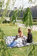 © ADDICTIVE STOCK - Three friends enjoying a picnic in a city park