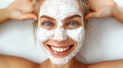 Happy woman in facial mask taking selfie at home for skincare routine and beauty treatment