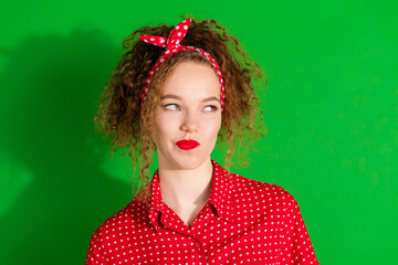 Sticker - Photo portrait of lovely young lady look skeptical empty space dressed stylish red retro garment isolated on green color background