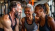 © pinkrabbit - Smiling group older of friends in sportswear laughing together while standing arm in arm in a gym after a workout, senior, healthy, friendship, adult, exercising, together, lifestyles