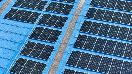 top view of grid of technology renewable solar energy. construction solar panels system on roof. Installing solar photovoltaic panel system. background of blue of solar cell system and structure roof.