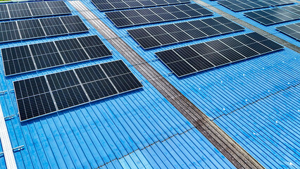 top view of grid of technology renewable solar energy. construction solar panels system on roof. Installing solar photovoltaic panel system. background of blue of solar cell system and structure roof.