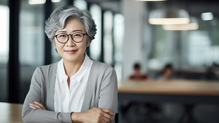 Poster - Senior  Female Office Worker looking at laptop,