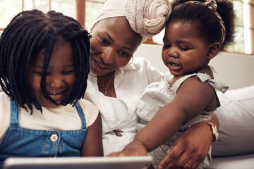 Canvas Print - Mother, children and tablet on sofa for elearning, education or development on weekend in living room. Digital, woman and black people with technology for app, subscription or playing game in home