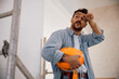 © Drazen - Tired manual worker taking break at construction site.
